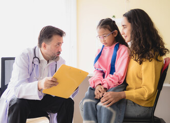 Doctor man care caucasian sitting use stethoscope check girl sick illness daughter who came to...