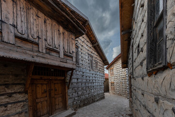 Fototapeta na wymiar Old houses made of wood, stone and mortar, empty streets.