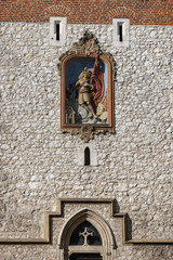 Medieval, gothic Florian Gate, statue of Saint Florian on facade, Krakow, Poland - obrazy, fototapety, plakaty