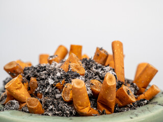 Ashtray full of cigarette butts. Ashtray with cigarette butts close-up.