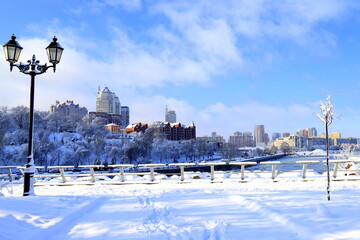 Fototapeta premium Winter city landscape, covered with snow with lantern.The best scenic view of winter street, big buildings, skyscrapers