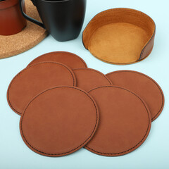 Leather table mats in brown colors. Concept shot, top view. Custom background view of leather table coaster. Stitched and leather table coaster