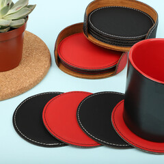 Leather table mats in different colors. Concept shot, top view. Custom background view of leather table coaster. Stitched and leather table coaster