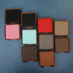 Leather table mats in different colors. Concept shot, top view. Custom background view of leather table coaster. Stitched and leather table coaster