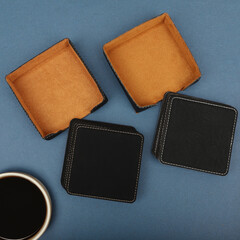 Leather table mats in different colors. Concept shot, top view. Custom background view of leather table coaster. Stitched and leather table coaster
