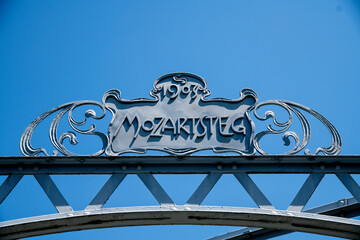 Historical Metal Mozartsteg Sign Against a Radiant Blue Sky