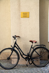 Bicycle Prohibition under Yellow Sign on Yellow Wall with Lock