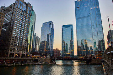 Fototapeta na wymiar Gorgeous Chicago, IL canal at dawn with reflective blue windows of skyscrapers, tourism, travel