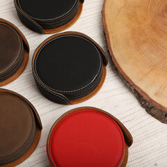 Leather table mats in different colors. Concept shot, top view. Custom background view of leather table coaster. Stitched and leather table coaster