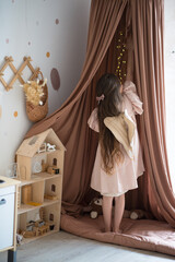 girl with wings plays with a doll house © Маргарита Медведева