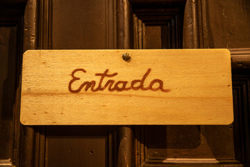 Traditional Catalan Entrance Sign on a Rustic Door