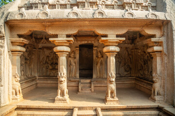 Varaha stone carved cave temple with ancient statues decoration, Mahabalipuram, Tondaimandalam region, Tamil Nadu, South India - obrazy, fototapety, plakaty