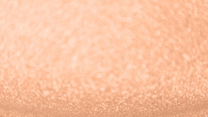 Abstract peach fuzz glitter texture as background with copy space. Shiny pattern in trendy color 2024 year Peach Fuzz.