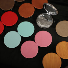 Naklejka premium Leather Round pocket makeup mirror in different colors. Concept shot, top view. Custom background, pocket makeup mirror. Travel pocket mirror, free space for text.