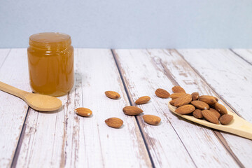 honey dripping on almond nuts isolated on white background