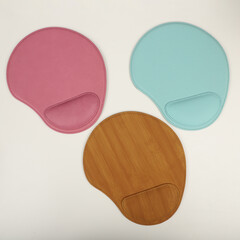 Leather mousepads in different colors. Concept shot, top view. Custom background, leather mousepad. Free space for text.