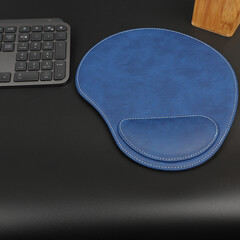 Leather mousepads in blue colors. Concept shot, top view. Custom background, leather mousepad. Free space for text.