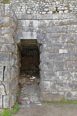 Fototapeta na wymiar Lake gate made of large stone blocks, monolithic stone ceiling on curved underside consoles, Butrint archaeological site. Sarande-Albania-160+