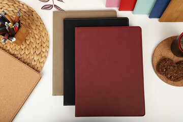 Leather portfolio. Concept shot, top view, portfolio in different colors and leather pen. Custom background flap portfolio view. Portfolio and accessories.