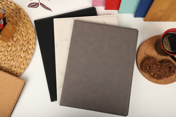 Leather portfolio. Concept shot, top view, portfolio in different colors and leather pen. Custom background flap portfolio view. Portfolio and accessories.