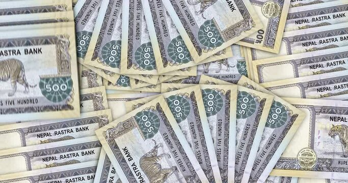 Nepal money Nepali rupees banknotes in a cash fan mosaic pattern loop. 500 NPR notes. Abstract concept of bank, finance, economy seamless and looped design background.