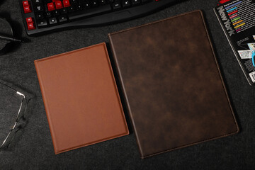 Leather portfolio. Concept shot, top view, portfolio in different colors and leather pen. Custom...