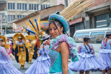 latina woman in folkloric costume at a Bolivian fiesta dancing morenada