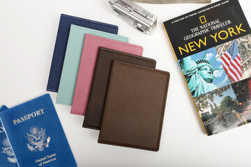 Obraz premium Leather passport wallet in different colors. Concept shot, top view. Custom background, Vacation and tourism concept. Free space for text. Stylish accessory for travelling