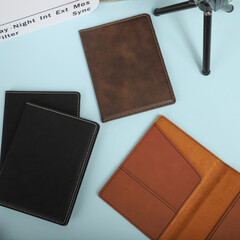Leather passport wallet in brown colors. Concept shot, top view. Custom background, Vacation and tourism concept. Free space for text. Stylish accessory for travelling