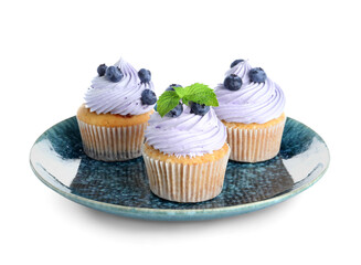 Plate of tasty cupcakes with blueberries on white background