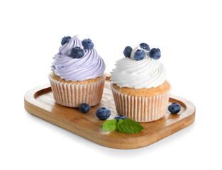 Wooden board of tasty cupcakes with blueberries on white background