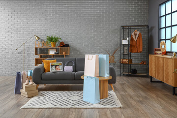 Interior of living room with sofa and shopping bags