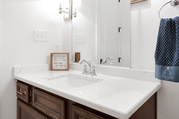 Guest Bathroom Vanity with Dual Sinks and Inspirational Quote Plaque on a Marble Countertop, Blue Christmas Towel
