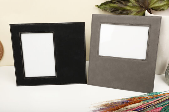 Leather photo frame in different colors. Concept shot. Stone wall background, Creative composition of modern living room interior. Free space for text and picture or photograph . Stylish home accessor