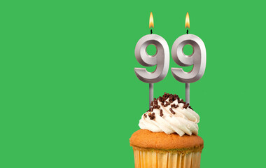 Birthday card with candle number 99 - Cupcake on green background