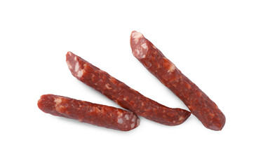 Thin dry smoked sausages isolated on white, top view