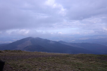 Morning view from the Dragobrat mountain peaks in Carpathian mountains, Ukraine. Cloudy and foggy...