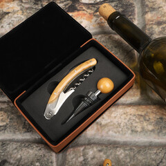 Wine opener set in leather box. Colorful leather boxes. Wine opener and cork. Close-up, top view,...
