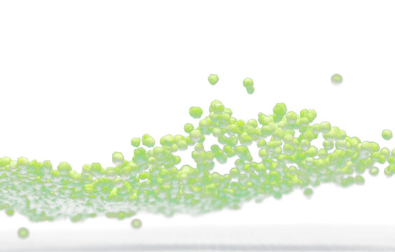 Sago seeds flying explosion, green grain wave floating. Abstract cloud fly splash in air. Green colored Sago seeds is material food. Black background Isolated selective focus blur