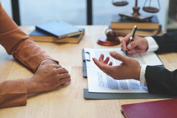 lawyer or judge is giving legal advice. to explaining about consultation terms and conditions to businesswoman before signing on contract at a law firm.