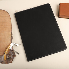 Leather Zipper Portfolio. Concept shot, top view, flap portfolio in black colors and leather pen....