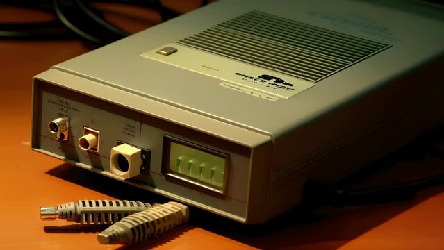 A closeup of a modem, demonstrating its ability to convert digital signals into analog signals to be sent over telephone lines or cable connections.
