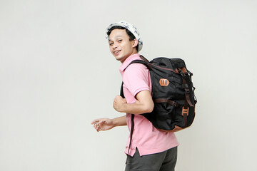 attractive asian man backpacker backpose with greeting hand palm. travelling concept. on isolated background