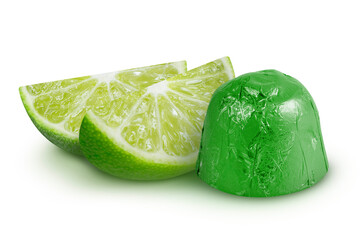 Lime slices and candy in green wrapper on isolated white background