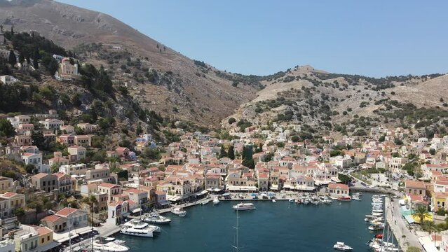 Revealing drone shot of the port of Symi Island, Greece