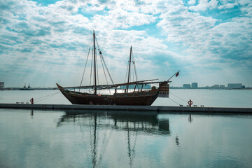Traditional boats called Dhows are anchored in the old Doha port - obrazy, fototapety, plakaty