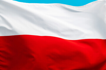 Naklejka premium Poland flag waving on blue background