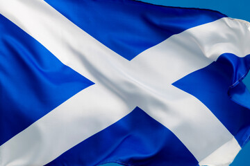Scottish flag waving on blue background