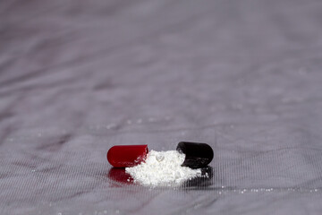 opened red and black pills with silver background