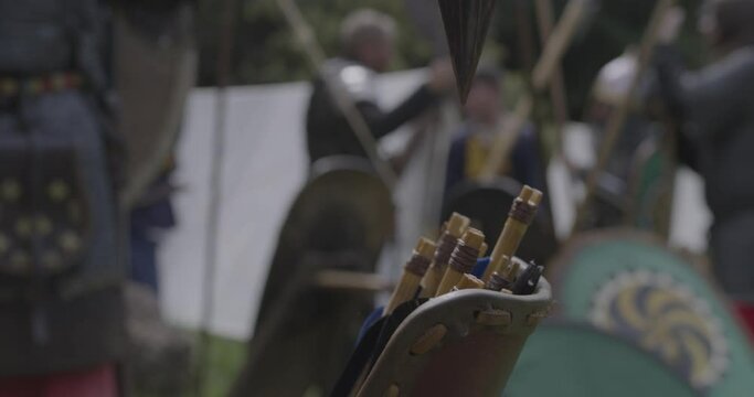 medieval female archer takes arrows